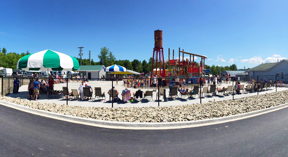 Kids playing on the play structure and splash pad at Yogi Bear's Jellystone Park